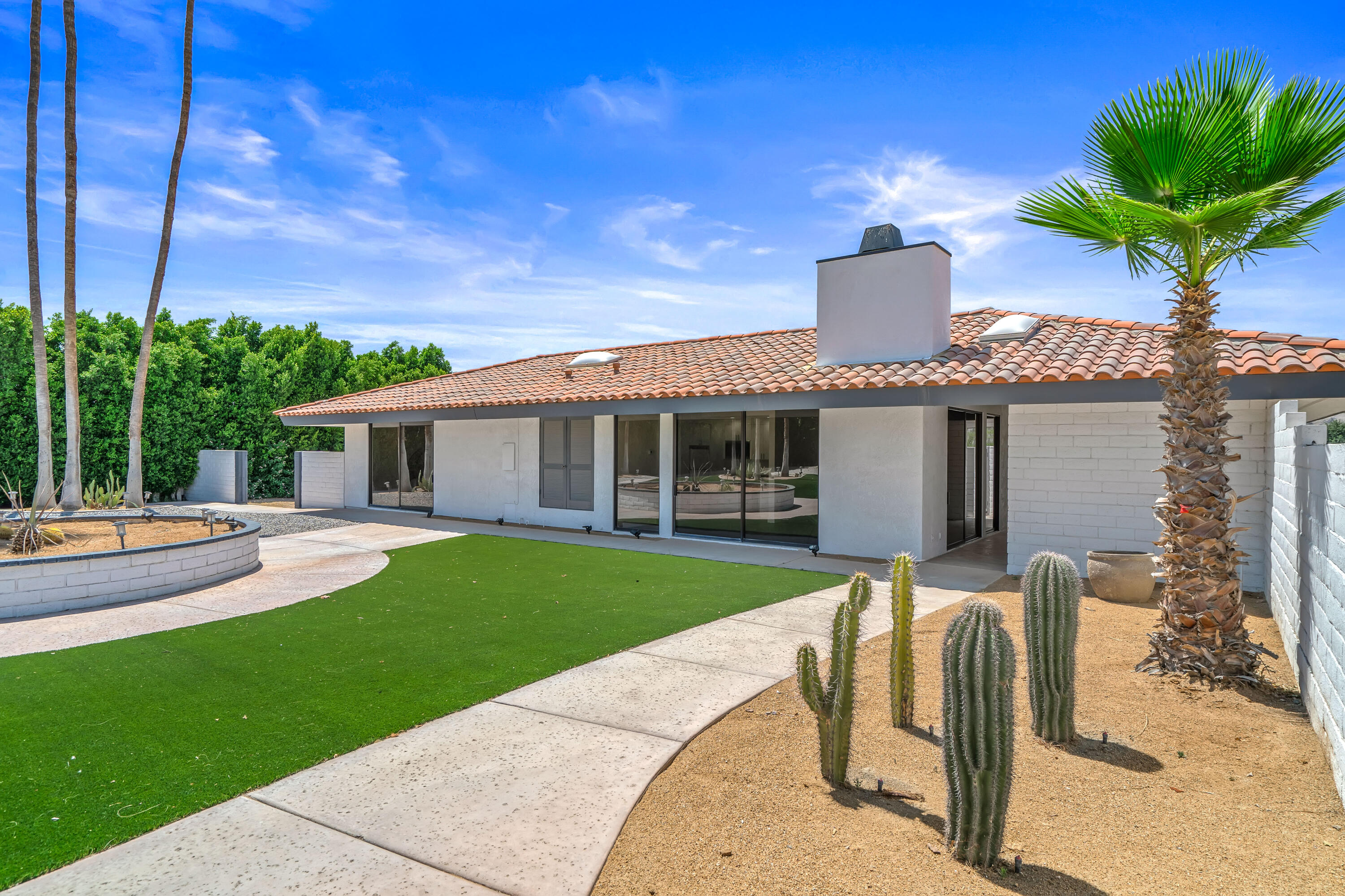 401 Iris Lane Rancho Mirage, CA 92270 - Photo 69 of 87 a front view of house with a garden and patio