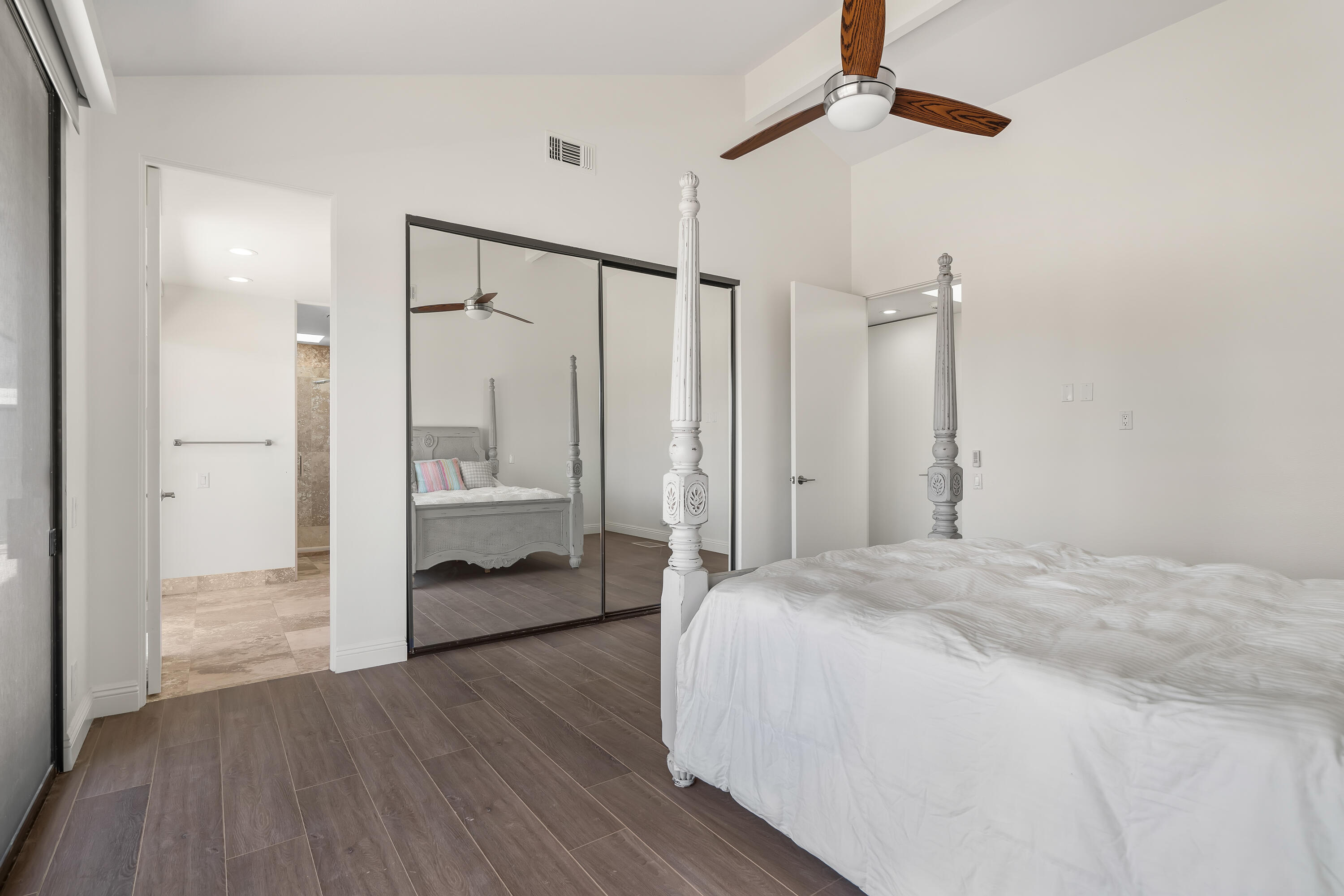 401 Iris Lane Rancho Mirage, CA 92270 - Photo 77 of 87 a spacious bedroom with a bed table and a walk in closet