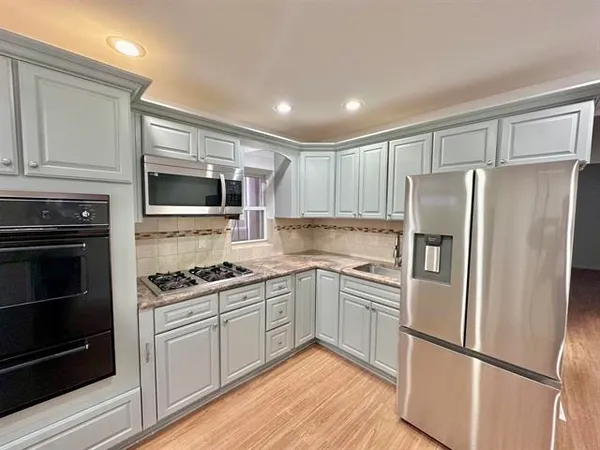 a kitchen with a refrigerator stove and microwave