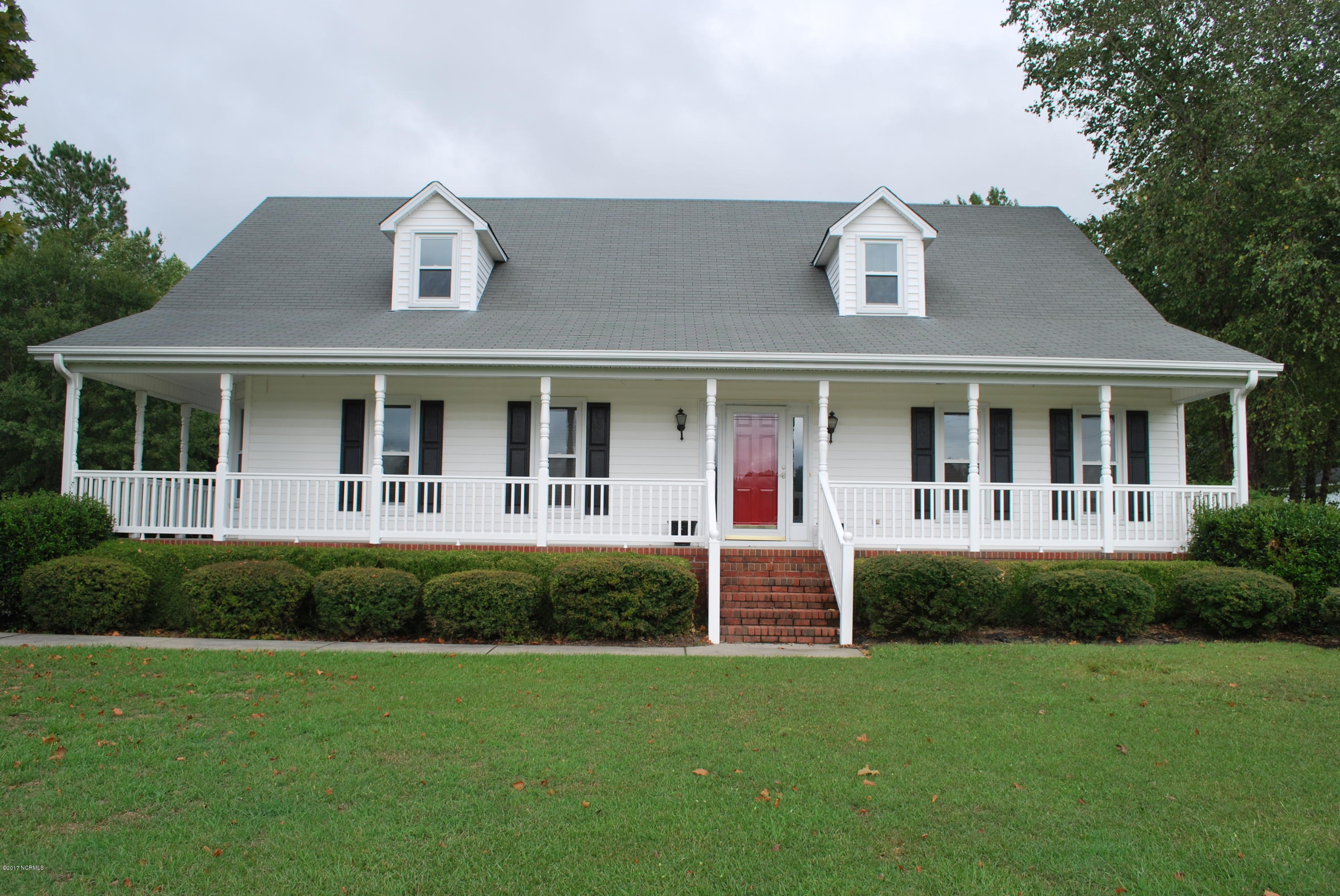 Covered porch with wrap-around on the side; nice yard with 1.88 lot