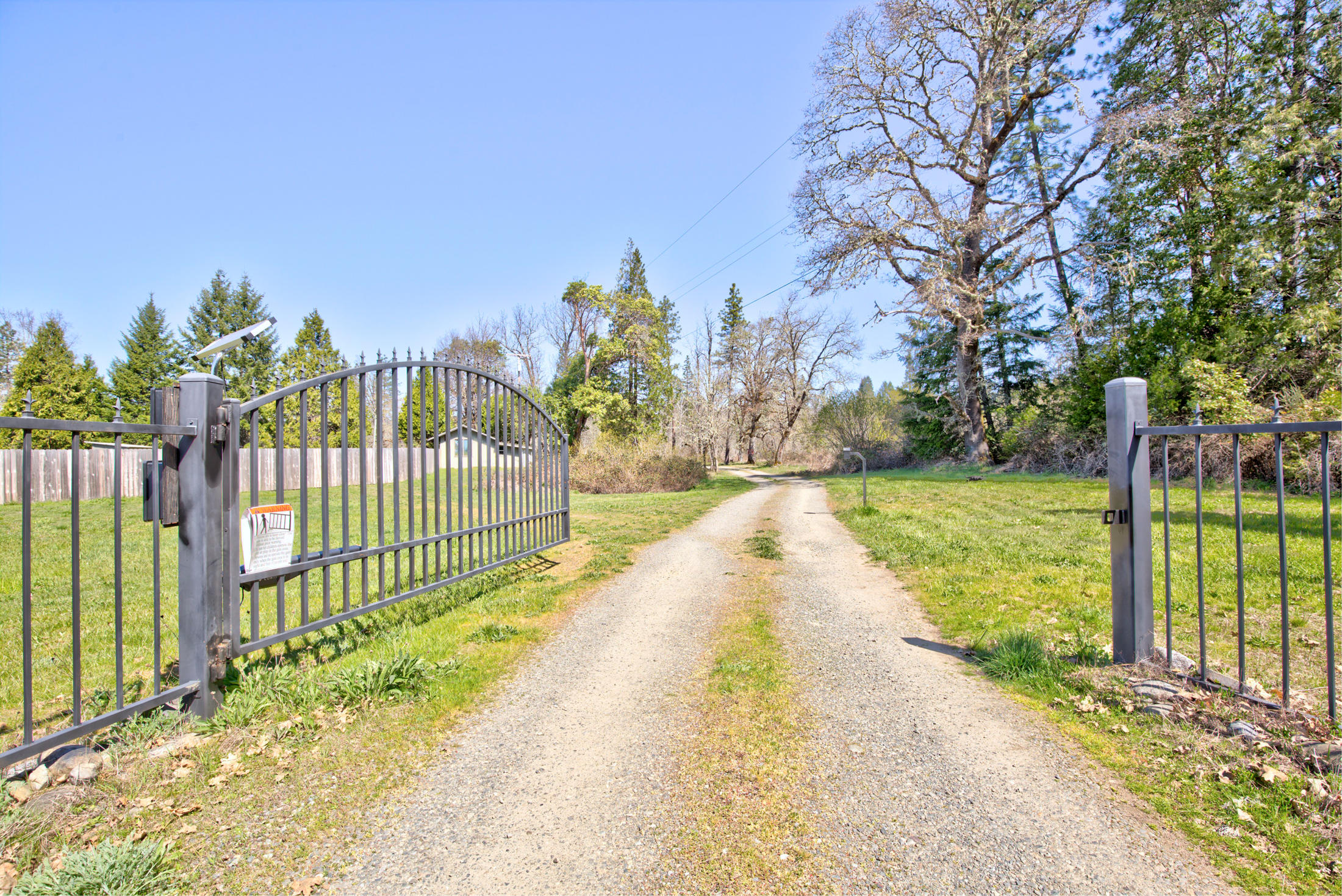 4550 Holland Loop Road Cave Junction, OR 97523 - Photo 35 of 39 a view of a garden with iron fence