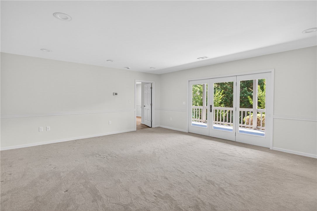 9 Lookout Lane Salem, SC 29676 - Photo 24 of 46 A spacious room with soft carpeting and ample natural light from glass doors leading to the outdoors.