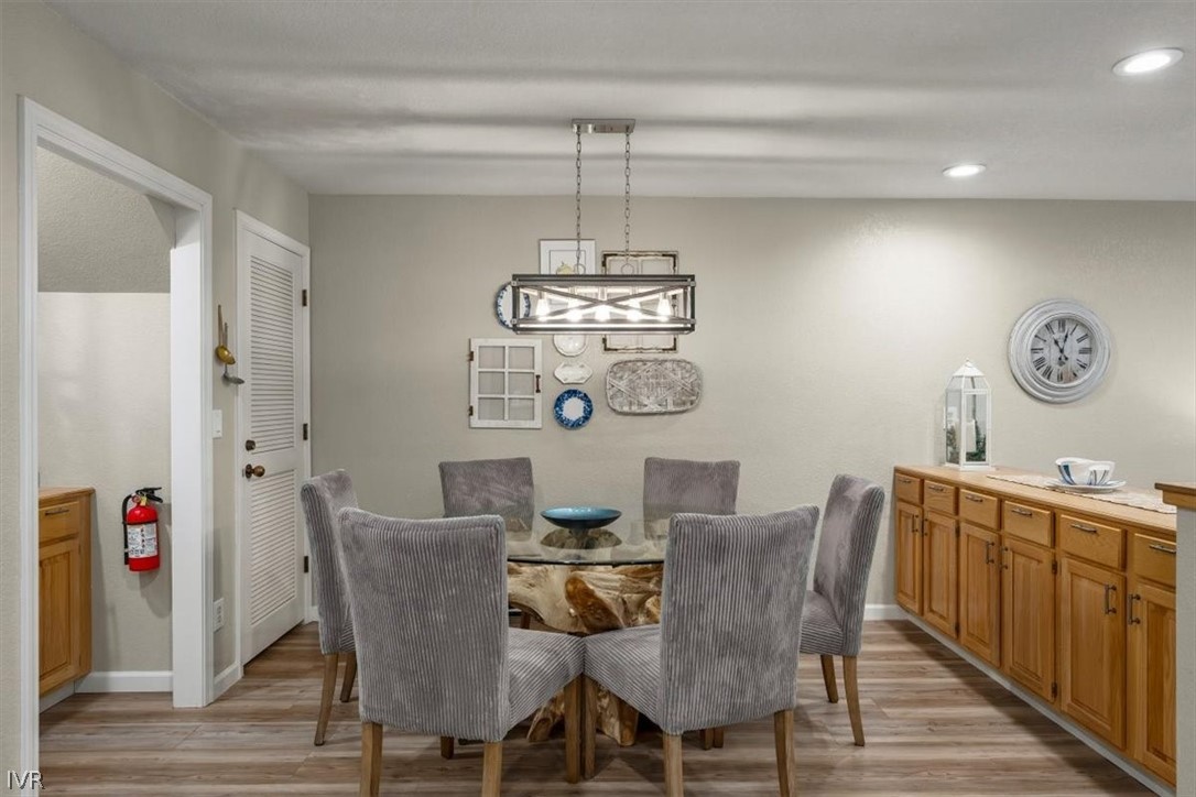 947 Incline Way, Unit 172 Incline Village, NV 89451 - Photo 9 of 30 a view of a dining room with furniture wooden floor and a chandelier