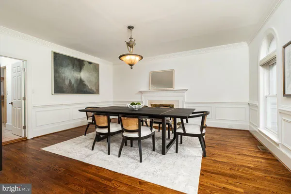 a view of empty room with wooden floor and fireplace