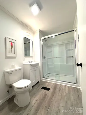a bathroom with a toilet sink and shower