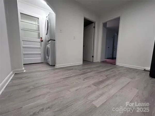 an empty room with wooden floor and closet