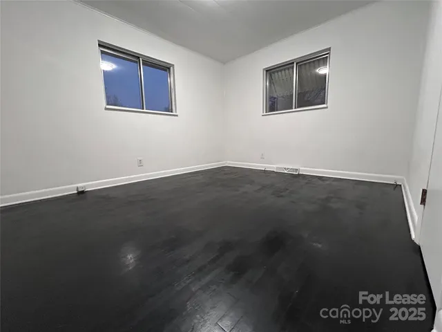 an empty room with wooden floor and closet