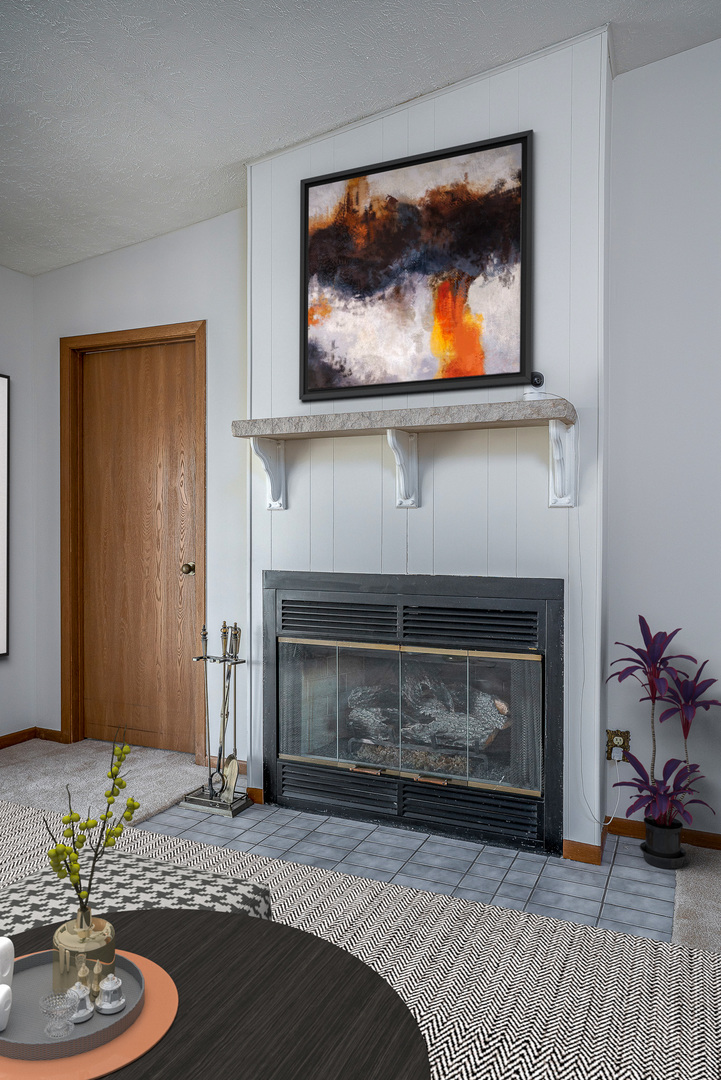 4231 26th Avenue Moline, IL 61265 - Photo 8 of 18 a living room with a fireplace and a flat screen tv
