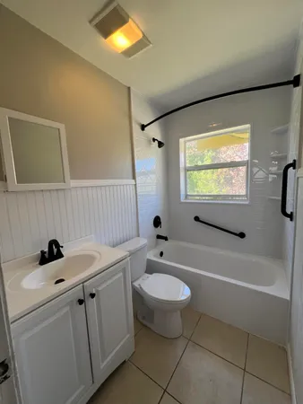 a bathroom with a sink a toilet and bathtub