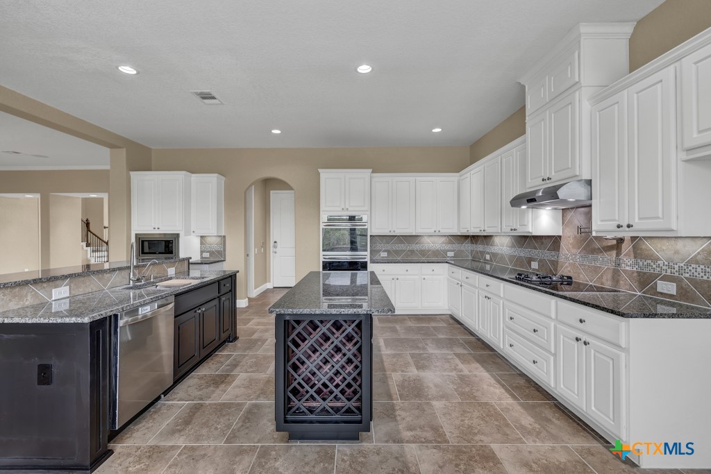 2194 Ranch Loop Drive New Braunfels, TX 78132 - Photo 11 of 48 a large kitchen with granite countertop lots of counter space and stainless steel appliances