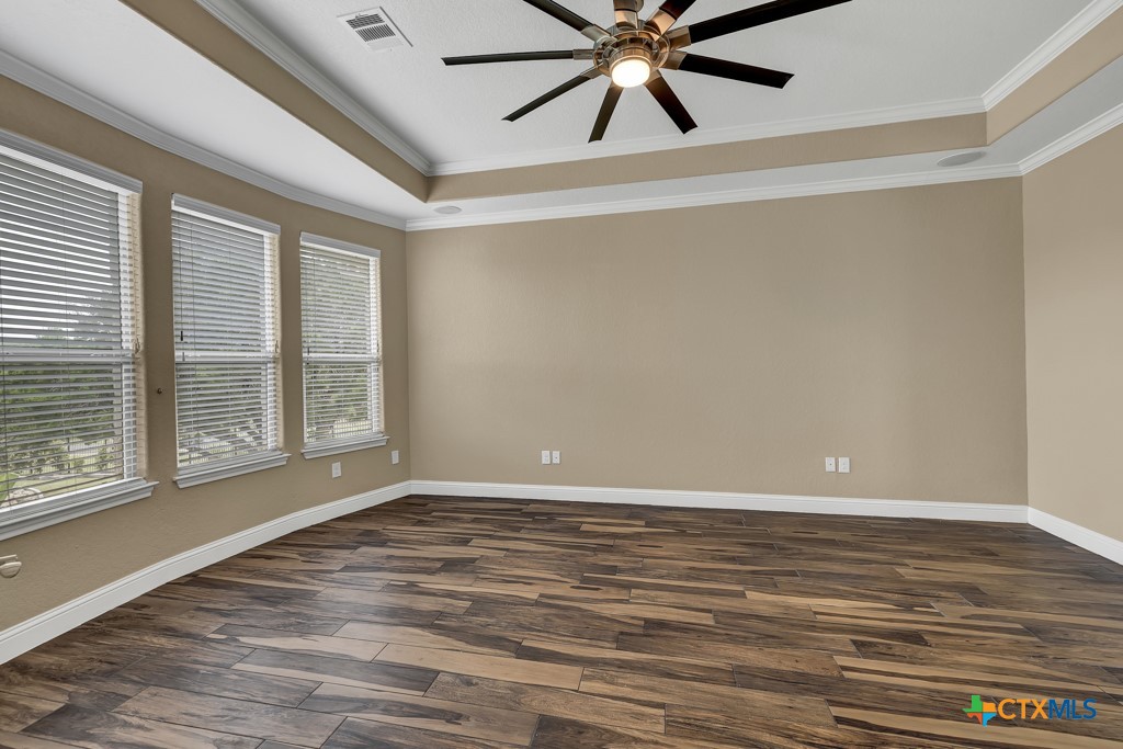 2194 Ranch Loop Drive New Braunfels, TX 78132 - Photo 15 of 48 a view of an empty room with window and wooden floor