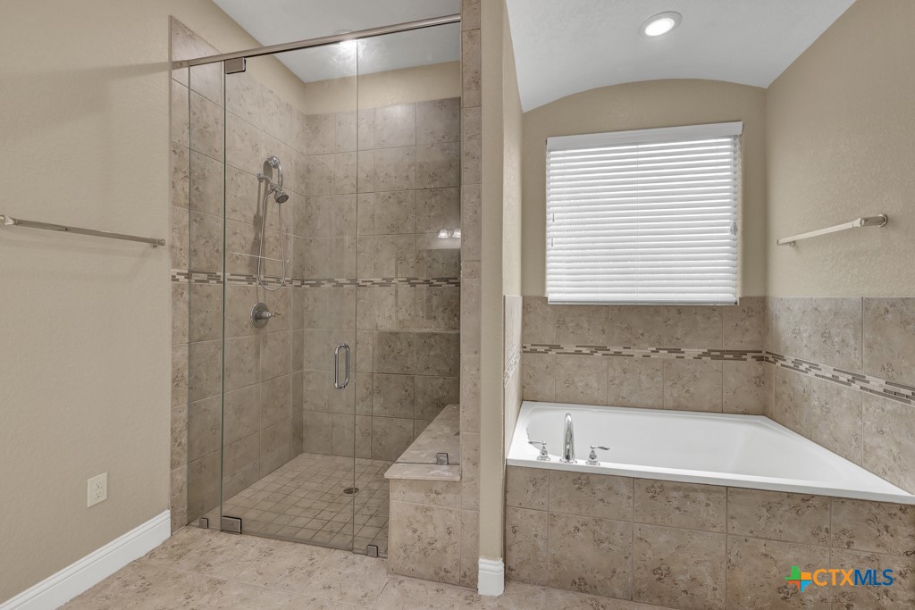 2194 Ranch Loop Drive New Braunfels, TX 78132 - Photo 17 of 48 a bathroom with a bathtub and a shower