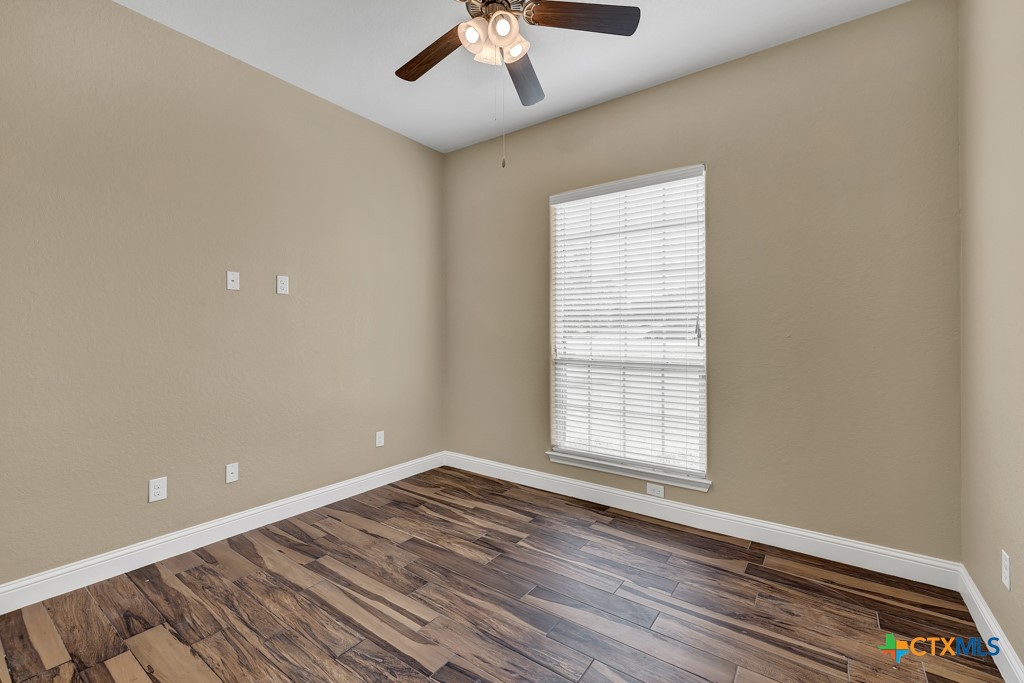 2194 Ranch Loop Drive New Braunfels, TX 78132 - Photo 19 of 48 a view of an empty room with wooden floor and a window