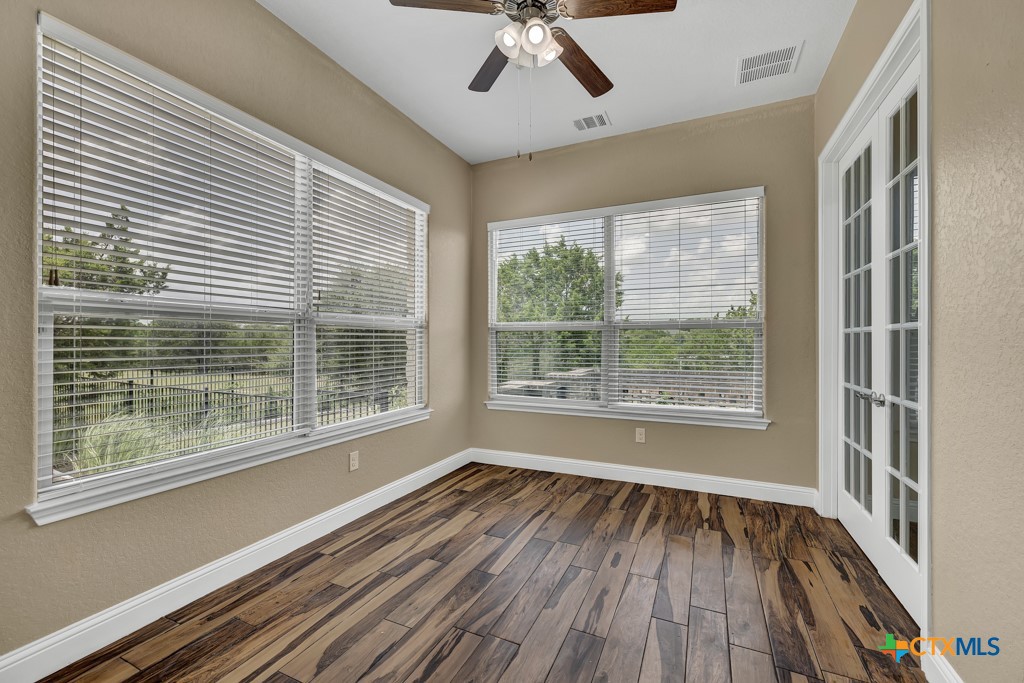 2194 Ranch Loop Drive New Braunfels, TX 78132 - Photo 21 of 48 a view of an empty room with wooden floor and a window