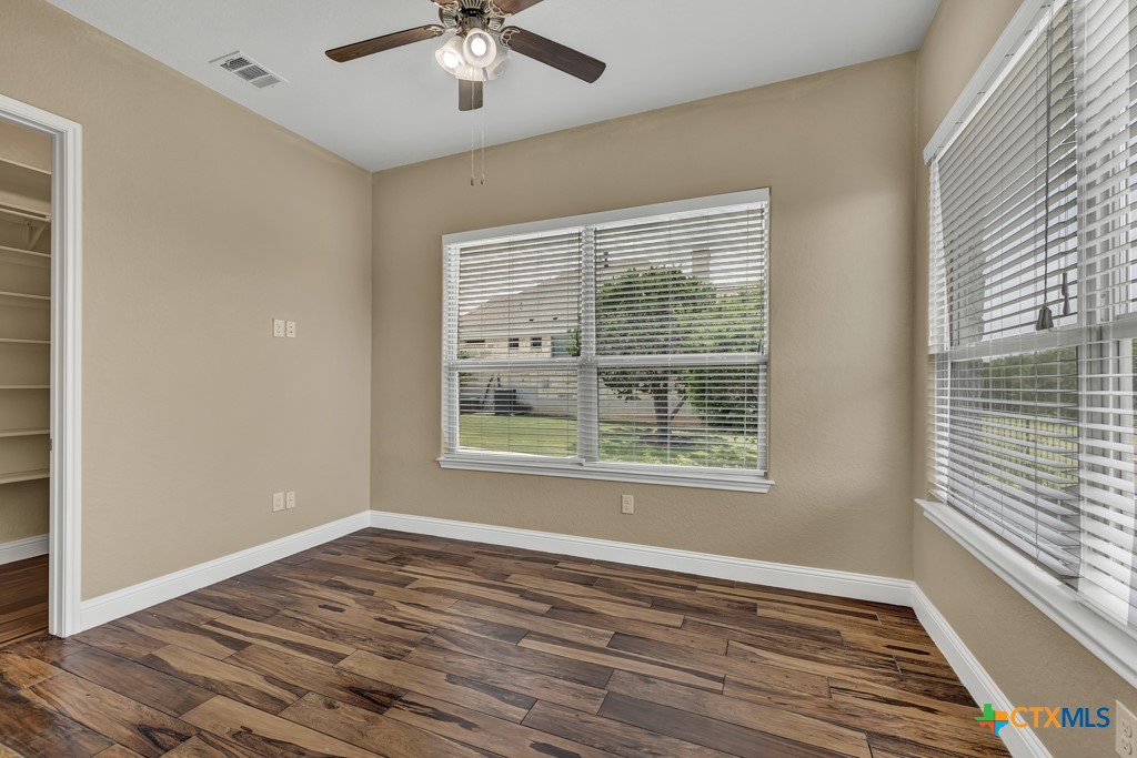 2194 Ranch Loop Drive New Braunfels, TX 78132 - Photo 23 of 48 a view of an empty room with wooden floor and a window