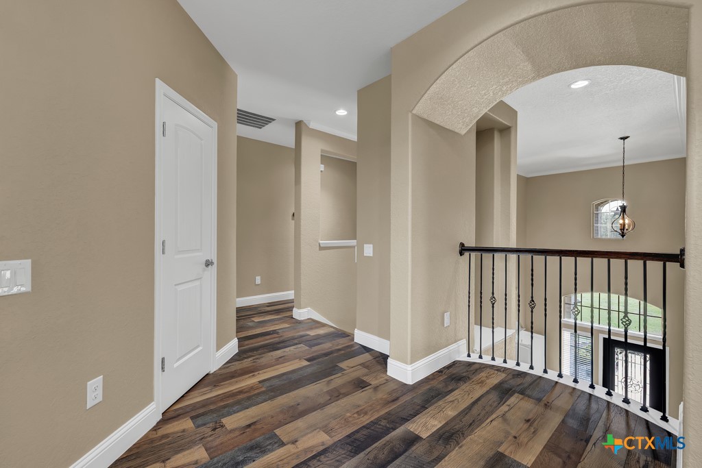 2194 Ranch Loop Drive New Braunfels, TX 78132 - Photo 24 of 48 a view of a hallway with wooden floor and a bathroom