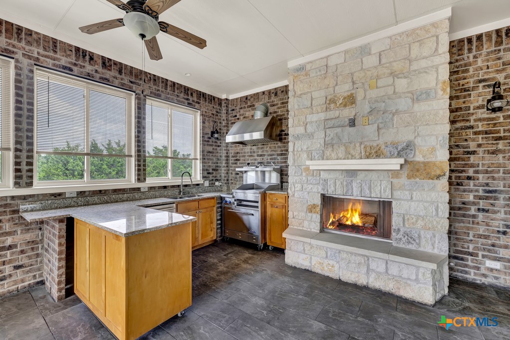 2194 Ranch Loop Drive New Braunfels, TX 78132 - Photo 33 of 48 a kitchen with furniture and a fireplace