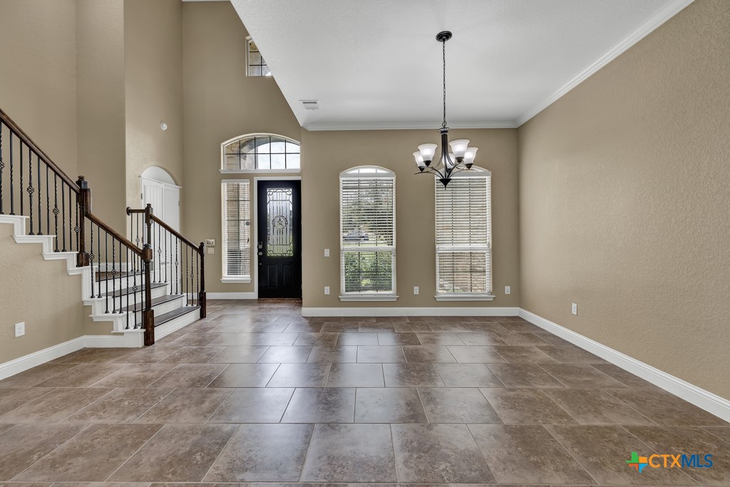 2194 Ranch Loop Drive New Braunfels, TX 78132 - Photo 4 of 48 a view of a hallway with windows and chandelier