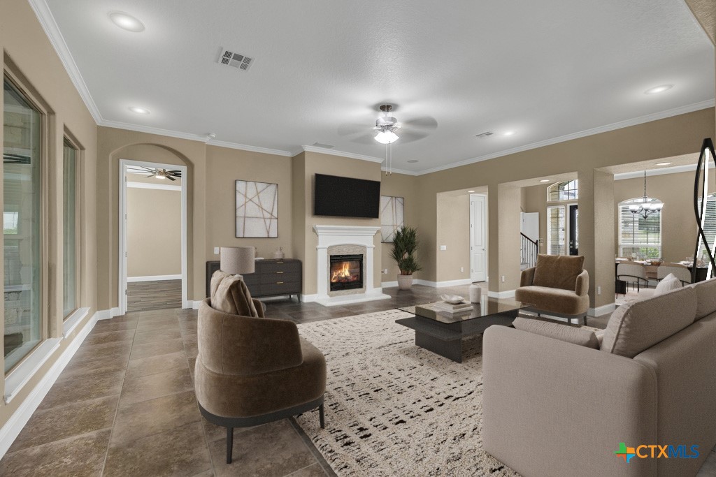 2194 Ranch Loop Drive New Braunfels, TX 78132 - Photo 7 of 48 a living room with furniture a fireplace and a flat screen tv