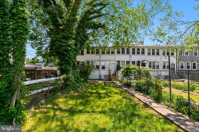 a view of house with a yard and swimming pool