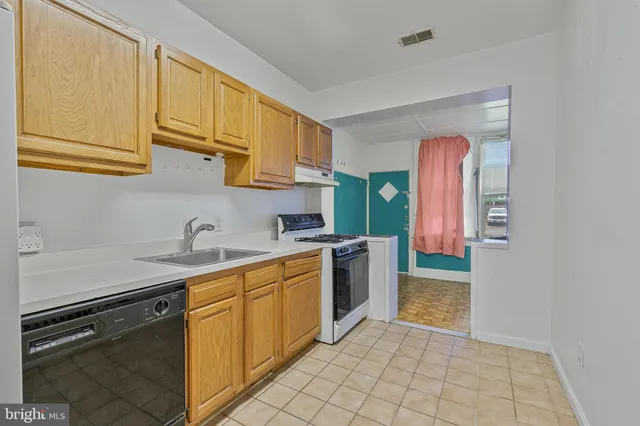 a kitchen with a sink stove and cabinets