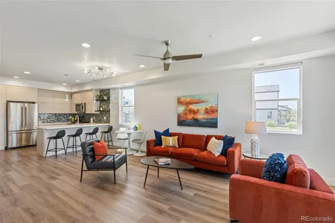 a living room with furniture and kitchen view