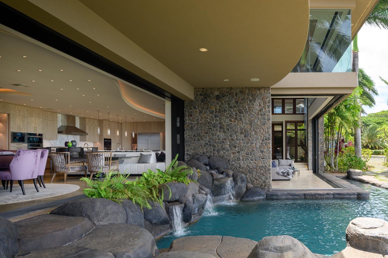 4809 Lower Honoapiilani Road Lahaina, HI 96761 - Photo 13 of 49 a view of a patio with table and chairs potted plants and a large tree
