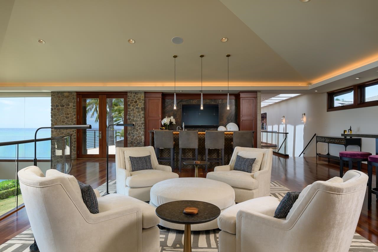 4809 Lower Honoapiilani Road Lahaina, HI 96761 - Photo 18 of 49 a living room with furniture a fireplace and a large window