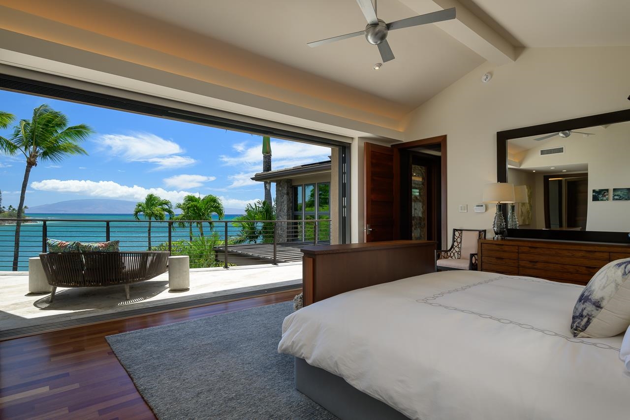 4809 Lower Honoapiilani Road Lahaina, HI 96761 - Photo 21 of 49 a bedroom with a large bed and a couch