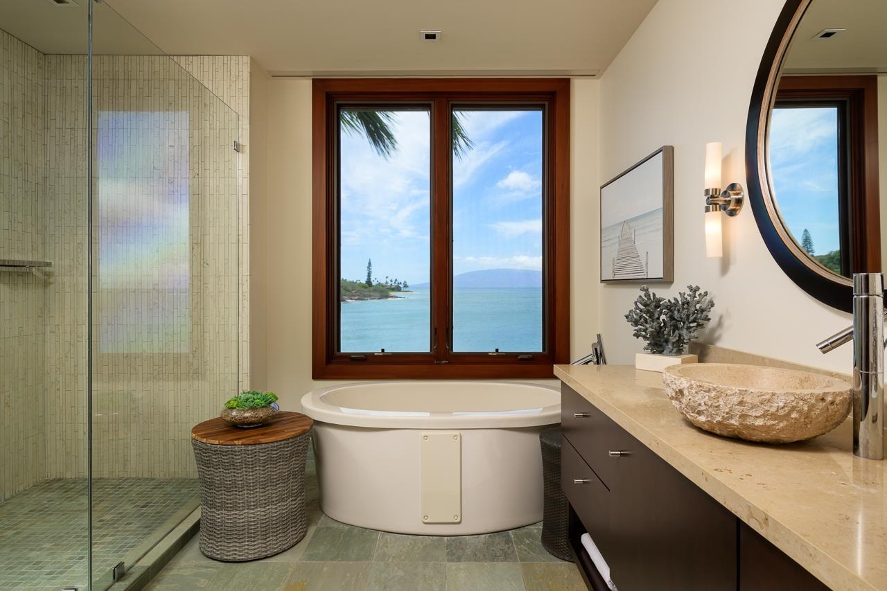 4809 Lower Honoapiilani Road Lahaina, HI 96761 - Photo 30 of 49 a bathroom with a granite countertop sink a toilet and a mirror