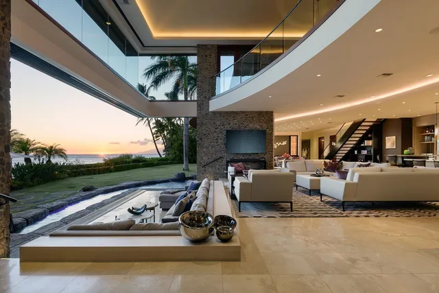 an aerial view of a house with a yard and lake view