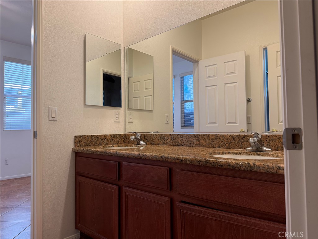 11012 Ragsdale Road Loma Linda, CA 92354 - Photo 18 of 27 a bathroom with a granite countertop sink and a mirror
