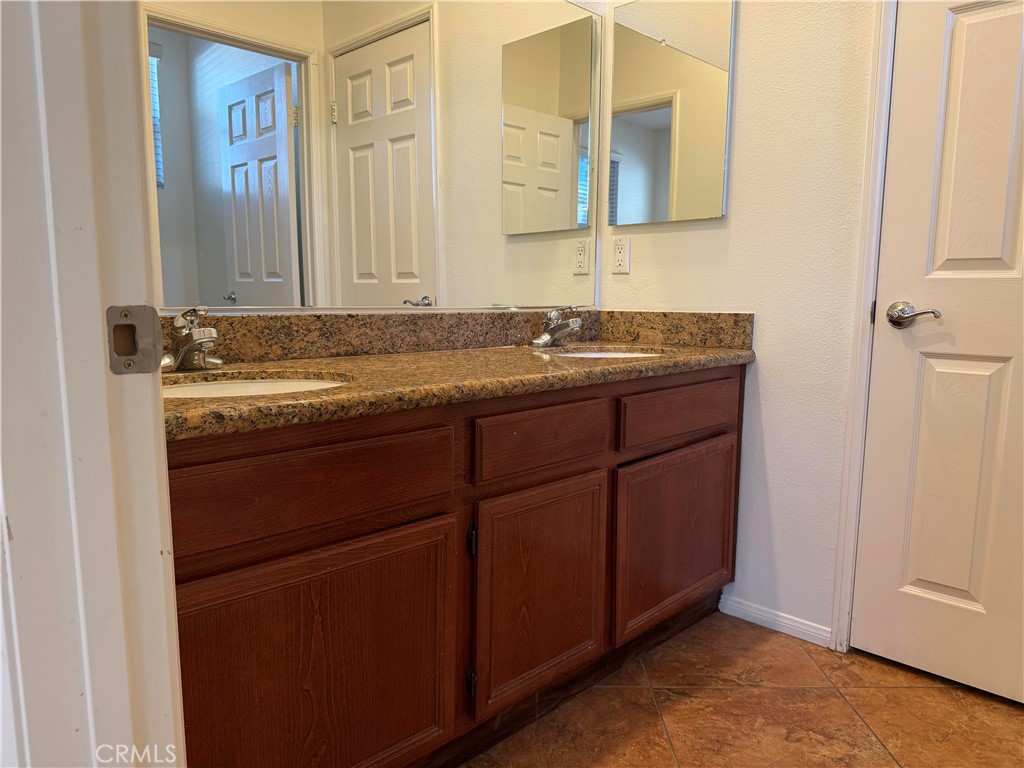 11012 Ragsdale Road Loma Linda, CA 92354 - Photo 20 of 27 a bathroom with a granite countertop sink and a mirror