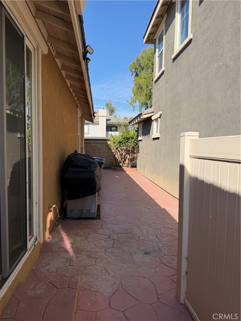 11012 Ragsdale Road Loma Linda, CA 92354 - Photo 23 of 27 a backyard of a house with potted plants and brick wall