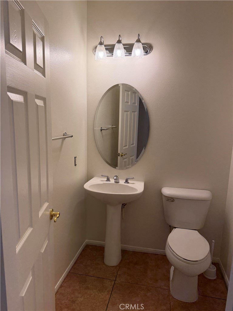 11012 Ragsdale Road Loma Linda, CA 92354 - Photo 9 of 27 a bathroom with a sink a toilet and a mirror
