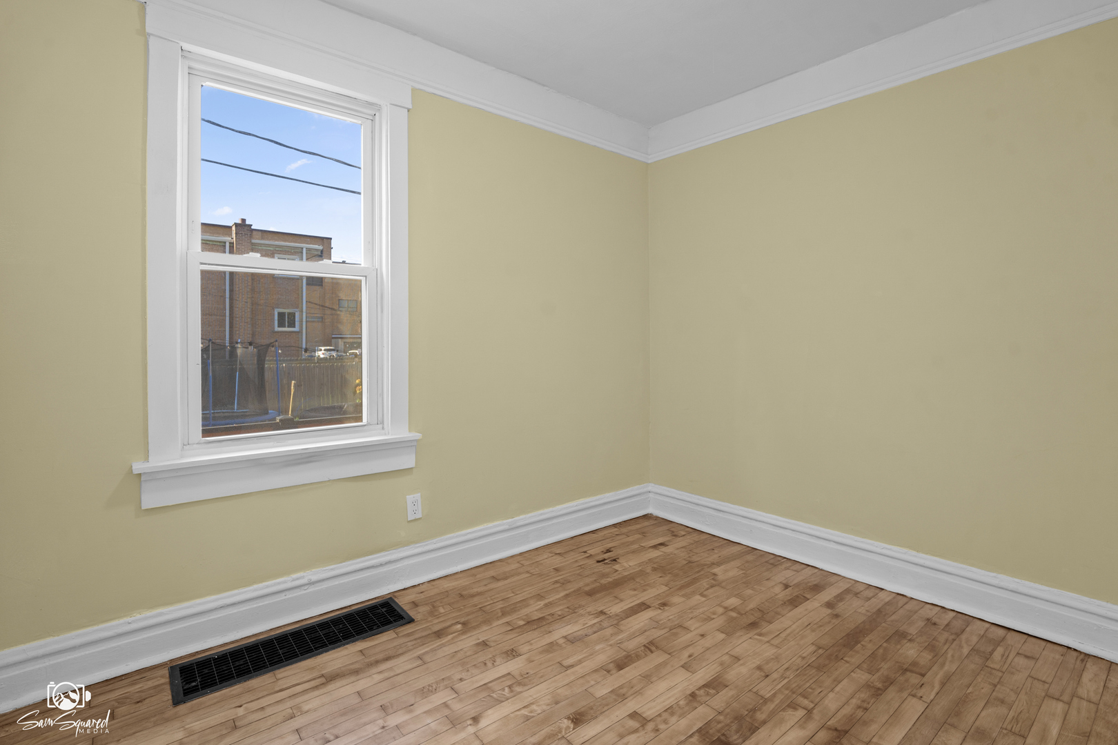 7236 West 63rd Place, Unit A Summit, IL 60501 - Photo 12 of 19 a view of an empty room with wooden floor and a window