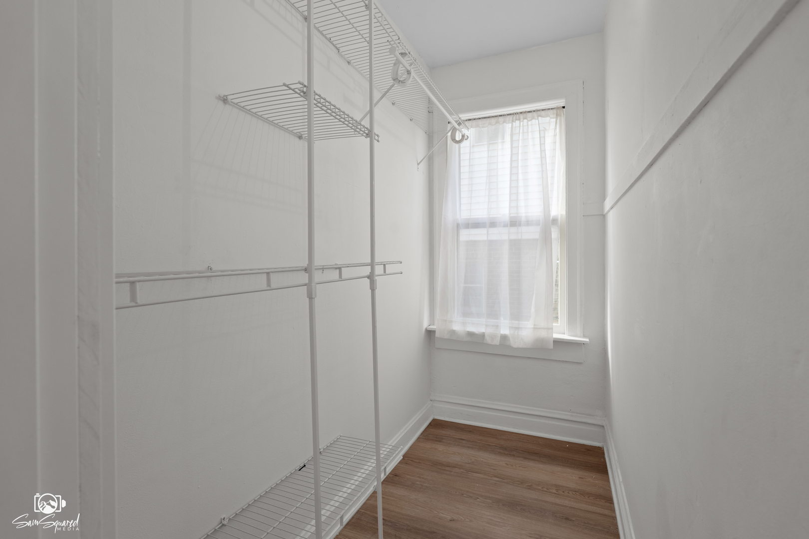 7236 West 63rd Place, Unit A Summit, IL 60501 - Photo 10 of 19 a view of an empty room with wooden floor and a window