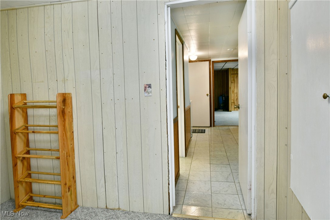 5578 Shaffer Road Northwest Warren, OH 44481 - Photo 25 of 48 Hall with wooden walls and carpet flooring
