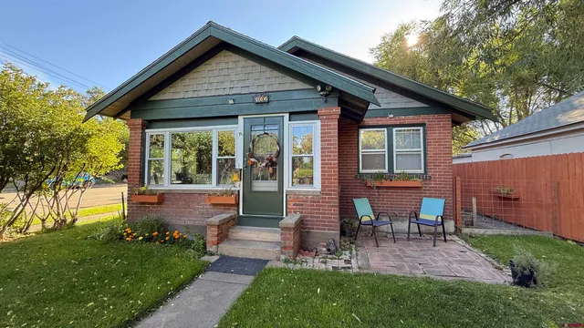 a view of a house with backyard porch and sitting area