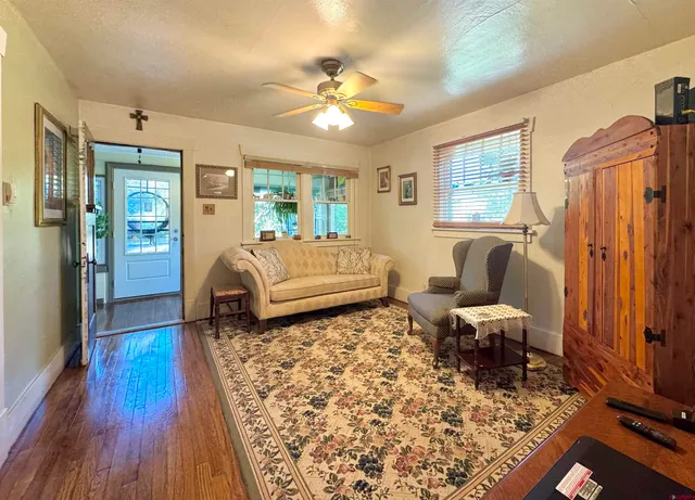 a living room with furniture and a wooden floor