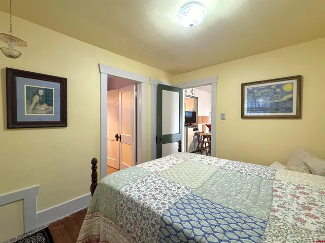 a bedroom with a large bed and a chandelier