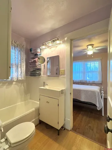 a bathroom with a bathtub a mirror a double vanity and a shower