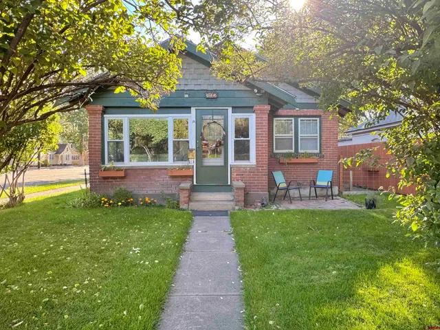 a front view of a house with a garden and patio