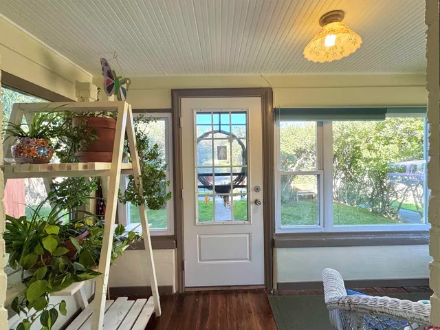 a view of a livingroom with furniture and floor to ceiling window