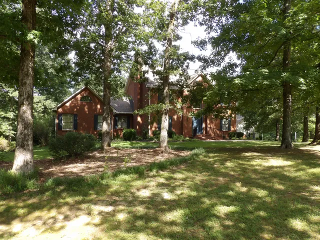 a kitchen with granite countertop a sink and a stove
