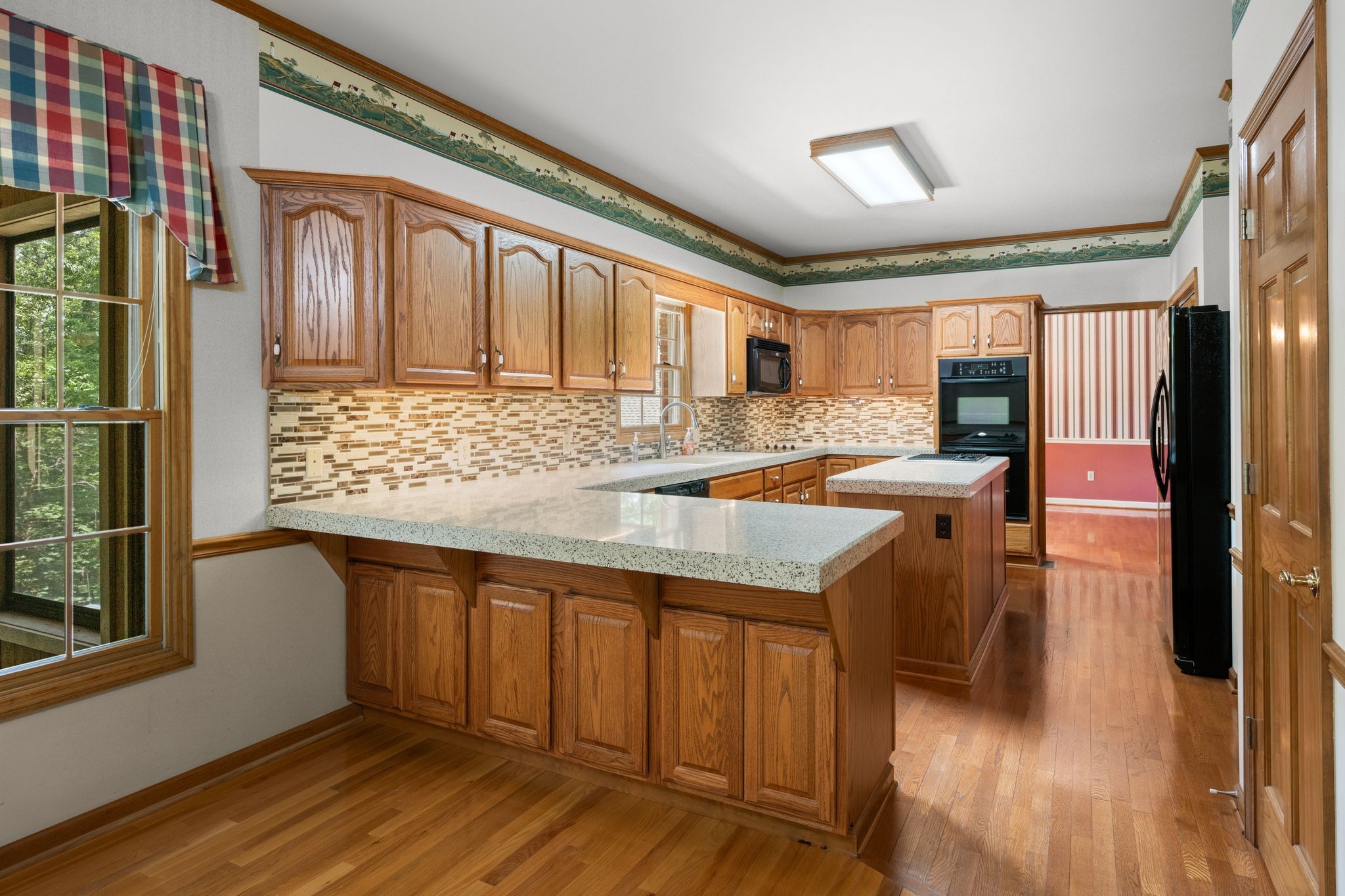 570 Gregson Place Waverly, TN 37185 - Photo 22 of 77 a kitchen with granite countertop a sink and a wooden floor