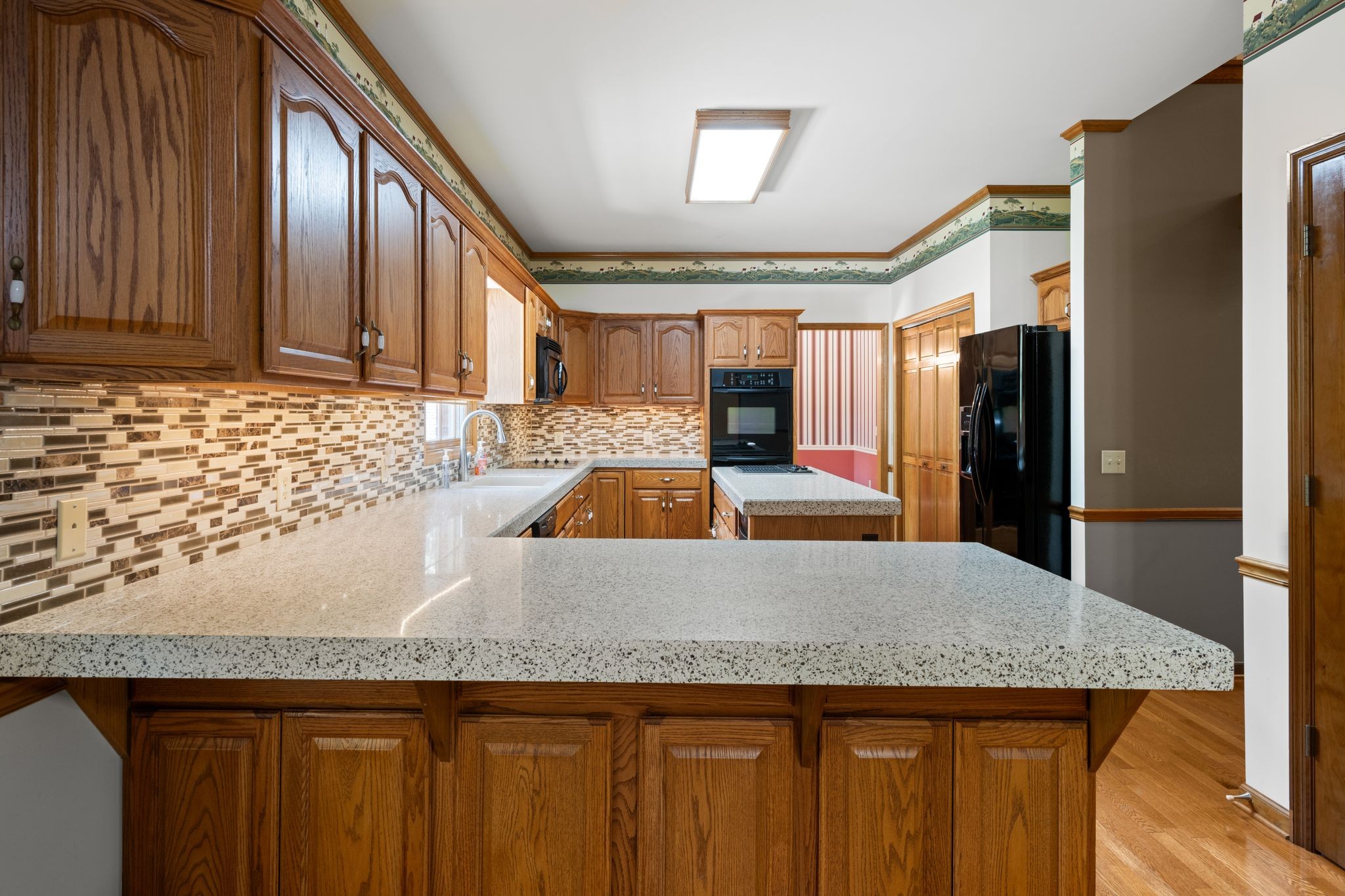 570 Gregson Place Waverly, TN 37185 - Photo 23 of 77 a kitchen with a sink a refrigerator and wooden cabinets