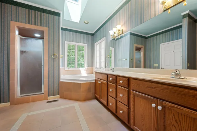 a bathroom with a double vanity sink mirror and toilet