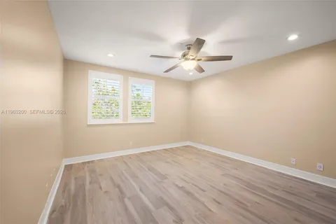 a bedroom with bed and a potted plant