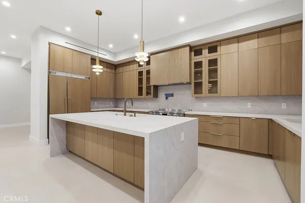 a large kitchen with a sink and lots of counter space